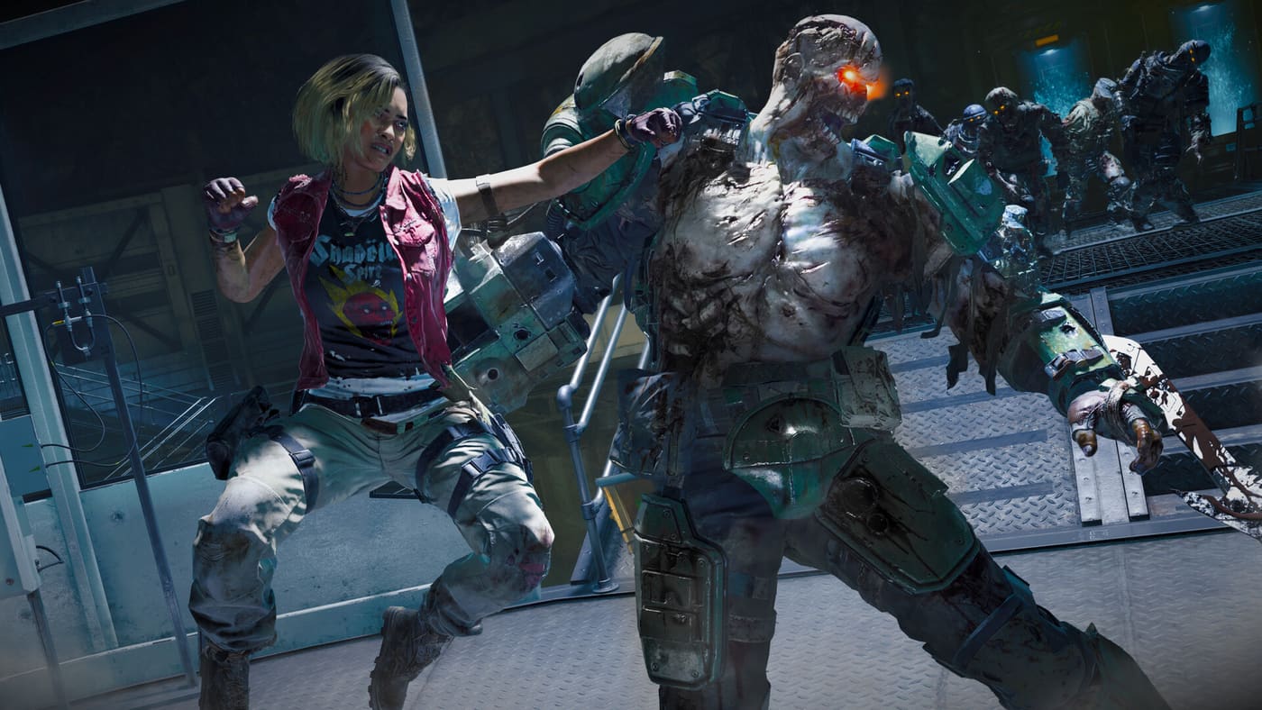 A Zombies player caught at melee range by an armoured zombie while several more close in behind it inside a lit interior — official Call of Duty®: Black Ops 6 screenshot supplied by Activision